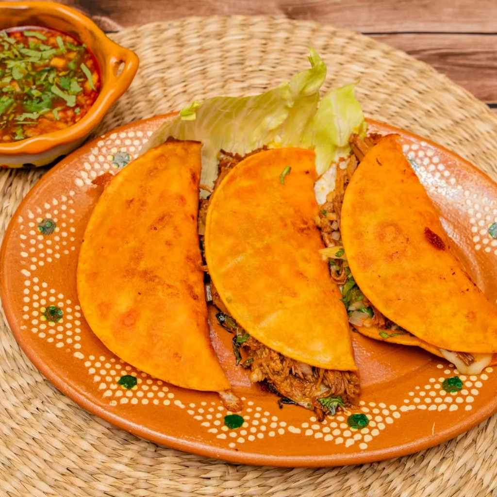 Birria tacos with cilantro and onions from Margaritas Tacos