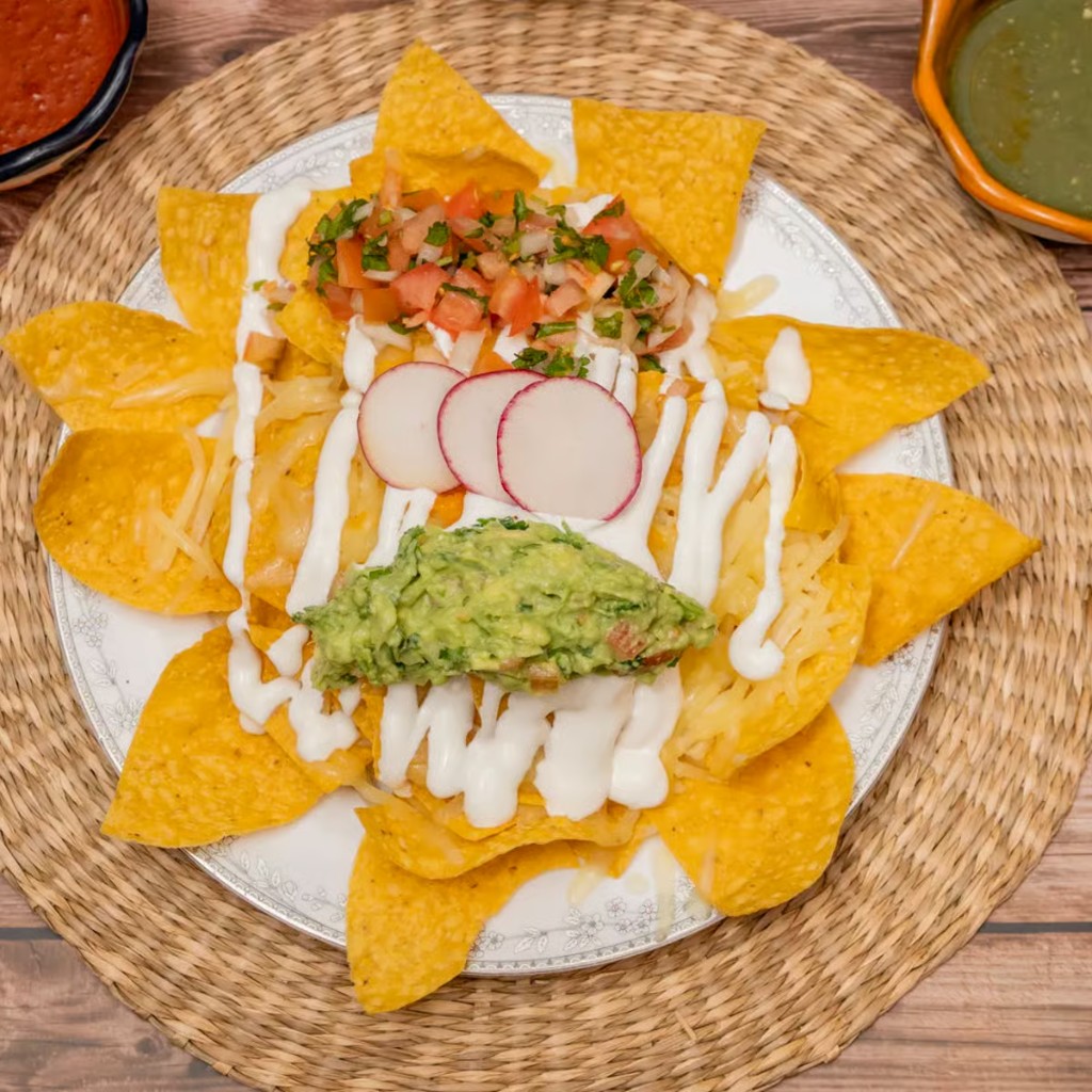 Loaded Mexican nachos with cheese, pico de gallo, and guacamole
